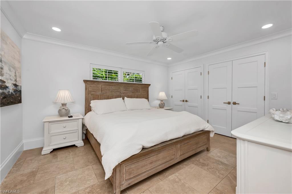 718 Old Trail Drive Naples, FL 34103 - Photo 8 of 18 Bedroom with two closets, ornamental molding, ceiling fan, and recessed lighting