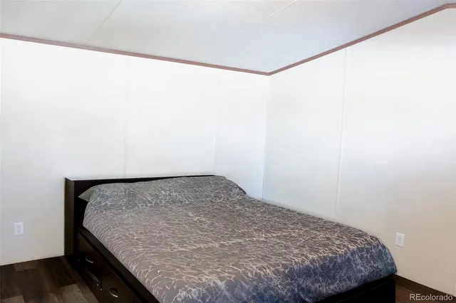a bed sitting in a bedroom next to a window