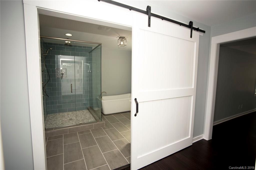 8236 Fairfield Forest Road Denver, NC 28037 - Photo 14 of 32 a bathroom with a shower and a glass door
