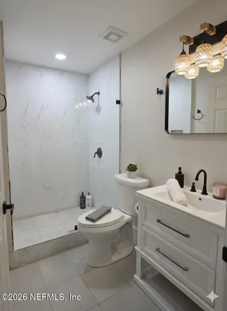 a bathroom with a double vanity sink mirror and toilet