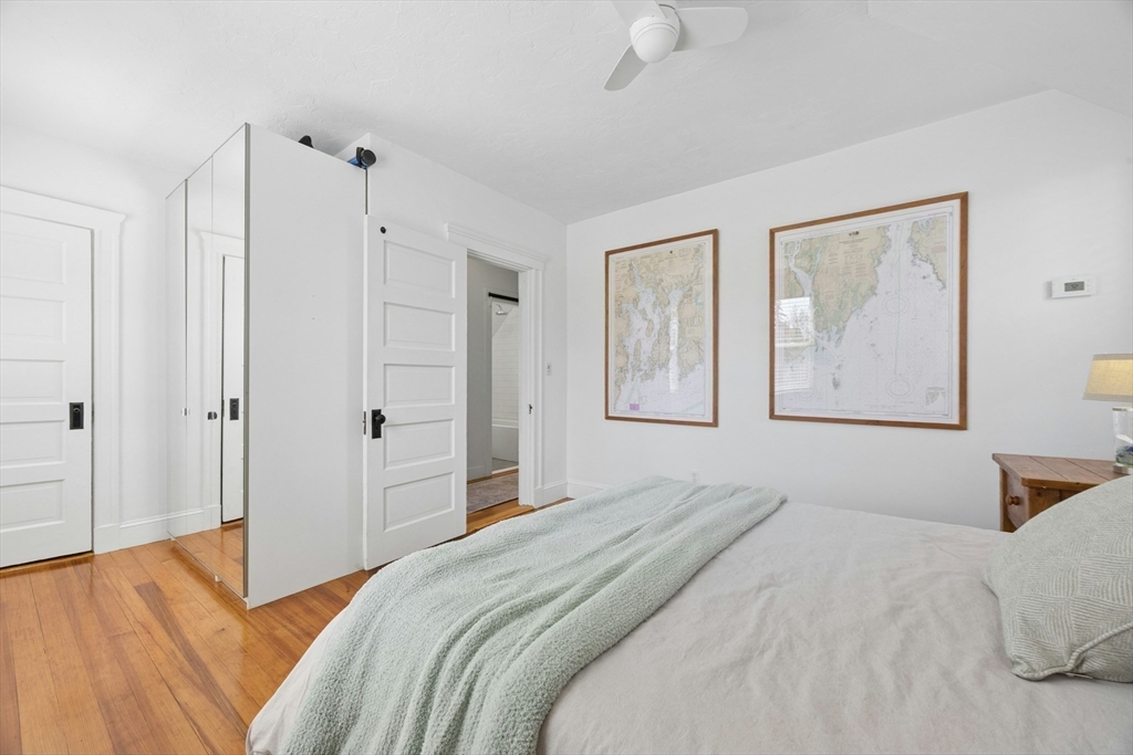 90 Florian Street Boston, MA 02130 - Photo 18 of 32 a bedroom with a large bed and a chandelier