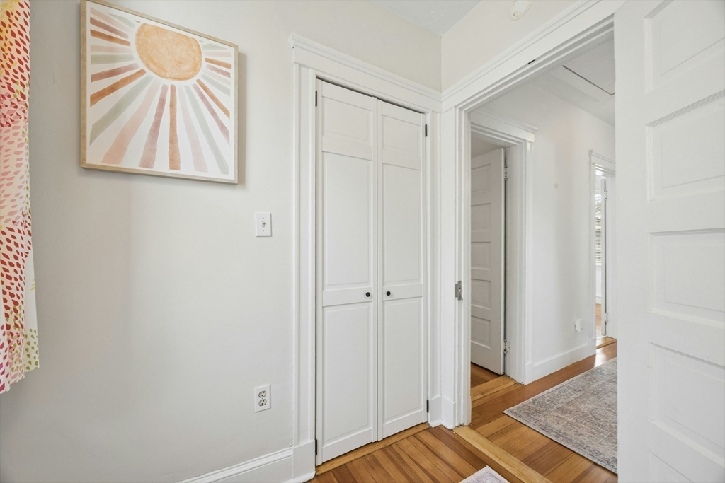 90 Florian Street Boston, MA 02130 - Photo 20 of 32 a view of a hallway with wooden floor and a cabinet