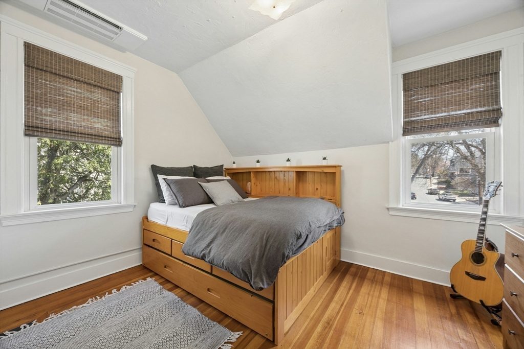 90 Florian Street Boston, MA 02130 - Photo 21 of 32 a bedroom with a bed and wooden floor