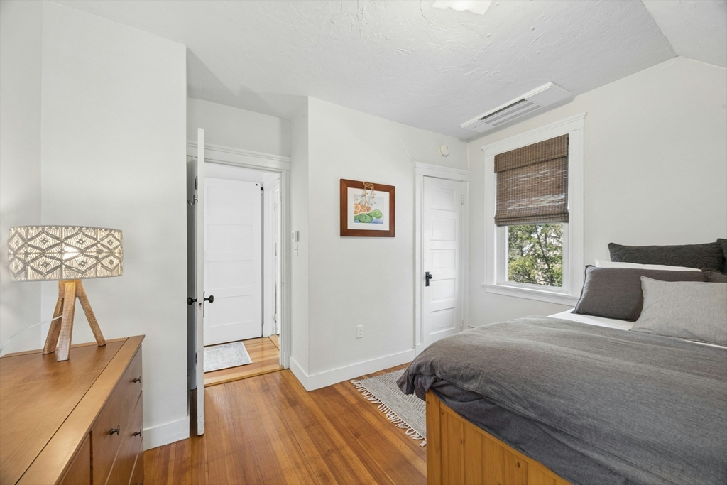 90 Florian Street Boston, MA 02130 - Photo 23 of 32 a bedroom with a bed and a lamp on table