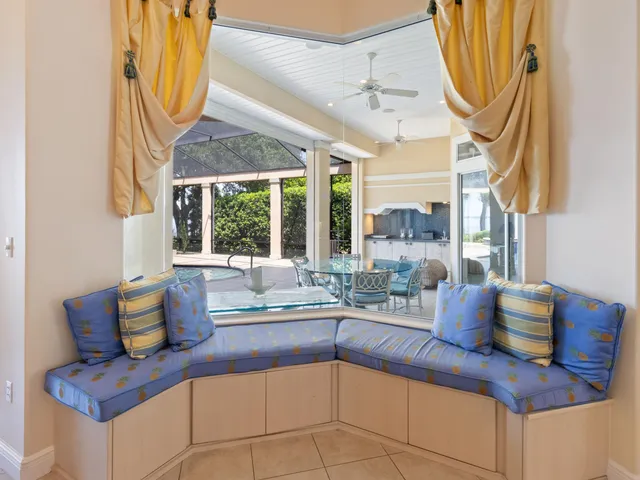 a dining room with furniture and a window