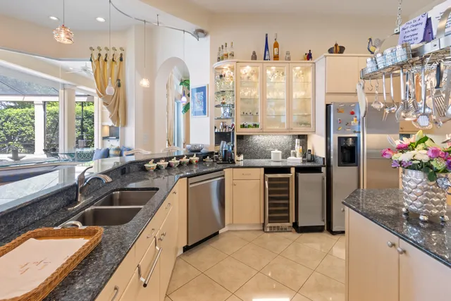 a kitchen with stainless steel appliances granite countertop a refrigerator and a sink