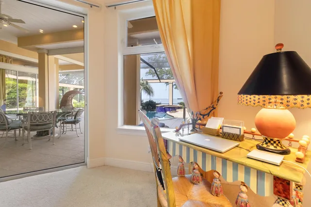 a spacious bedroom with a bed and a chandelier