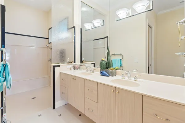 a bathroom with a shower sink and mirror