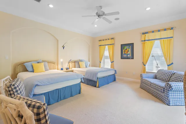 a bedroom with furniture and a large window