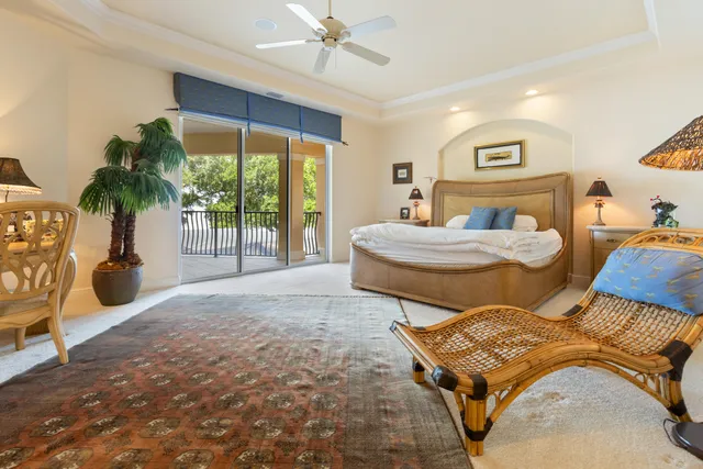a spacious bedroom with a bed and a chandelier
