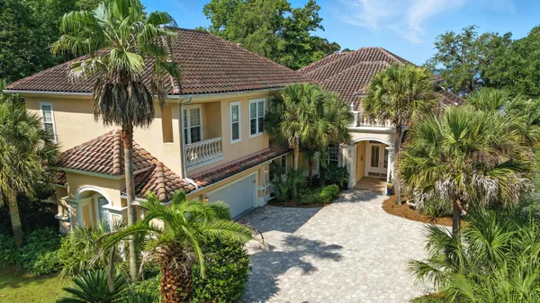 an aerial view of a house with a yard and lake view