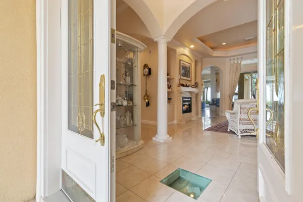 a view of a hallway with wooden floor and furniture
