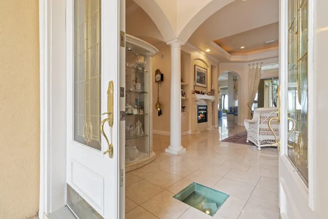 a view of a hallway with wooden floor and furniture