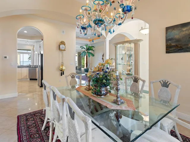 a view of a dining room with furniture and chandelier