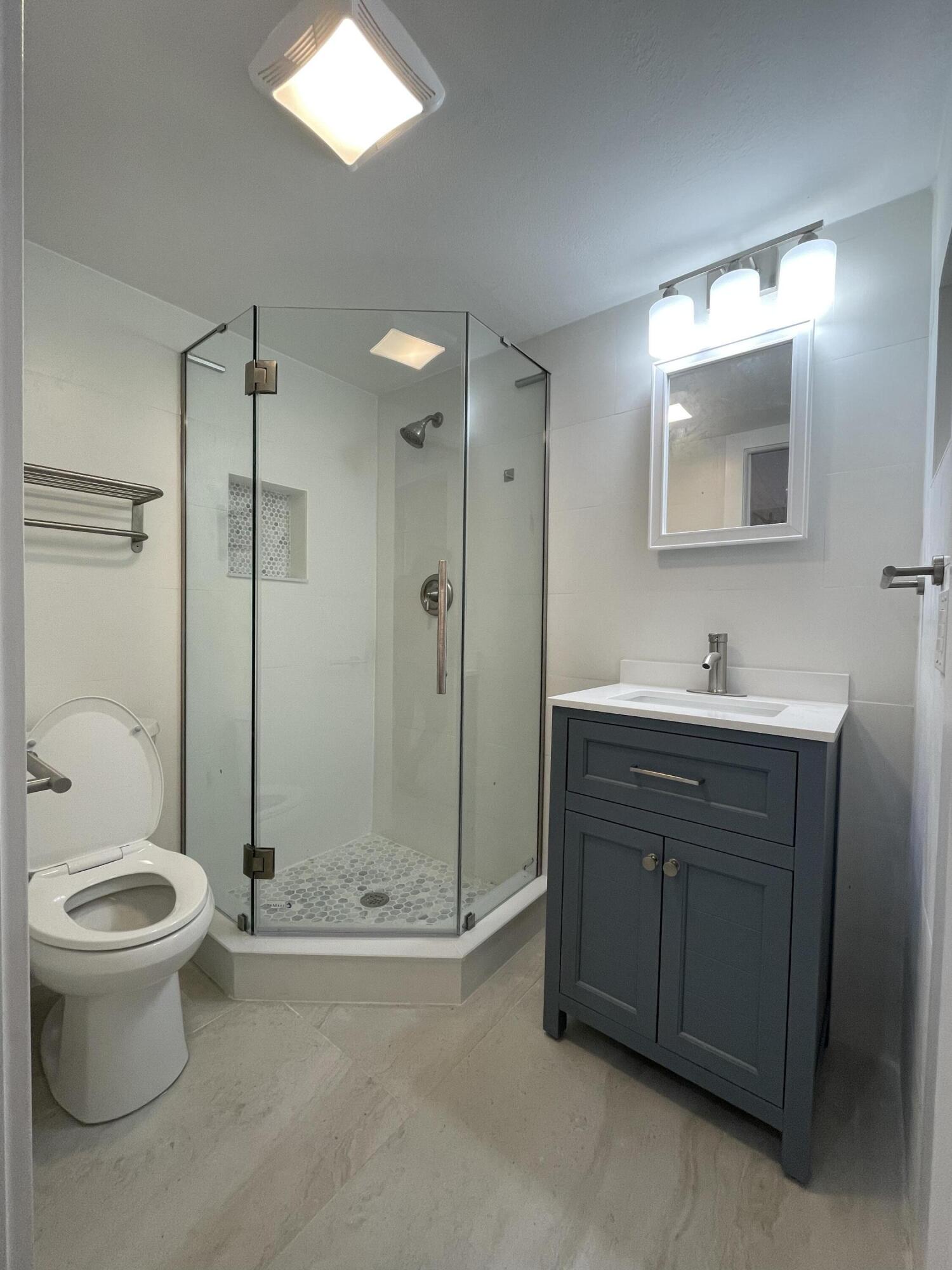 316 Southeast 1st Street, Unit 4 Boynton Beach, FL 33435 - Photo 2 of 16 a bathroom with a sink toilet and shower