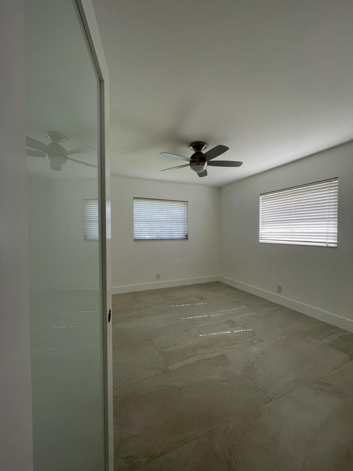 316 Southeast 1st Street, Unit 4 Boynton Beach, FL 33435 - Photo 5 of 16 a view of a room that has a window in it