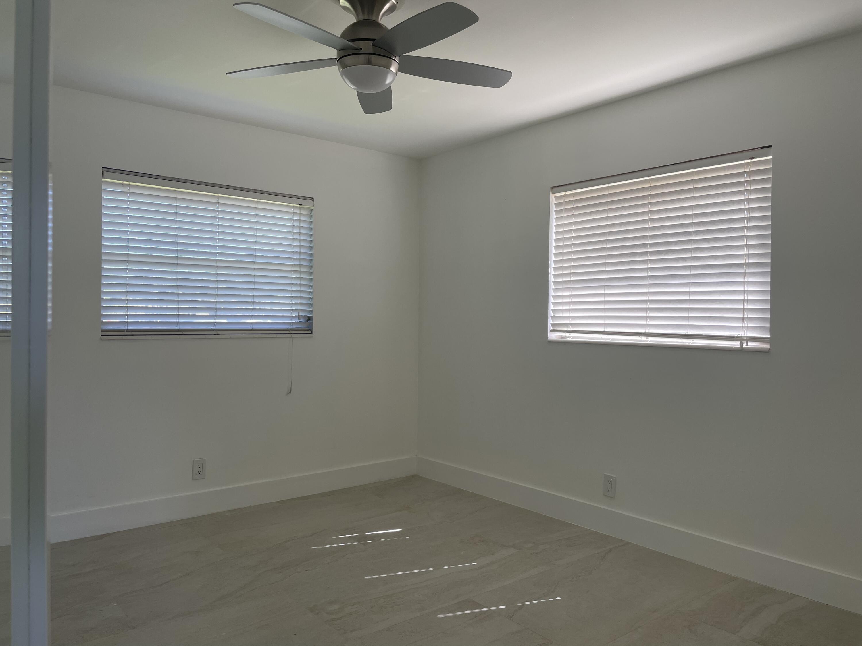 316 Southeast 1st Street, Unit 4 Boynton Beach, FL 33435 - Photo 6 of 16 an empty room with a window and a fan