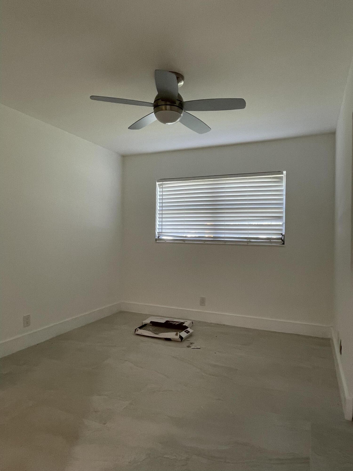 316 Southeast 1st Street, Unit 4 Boynton Beach, FL 33435 - Photo 8 of 16 an empty room with a window