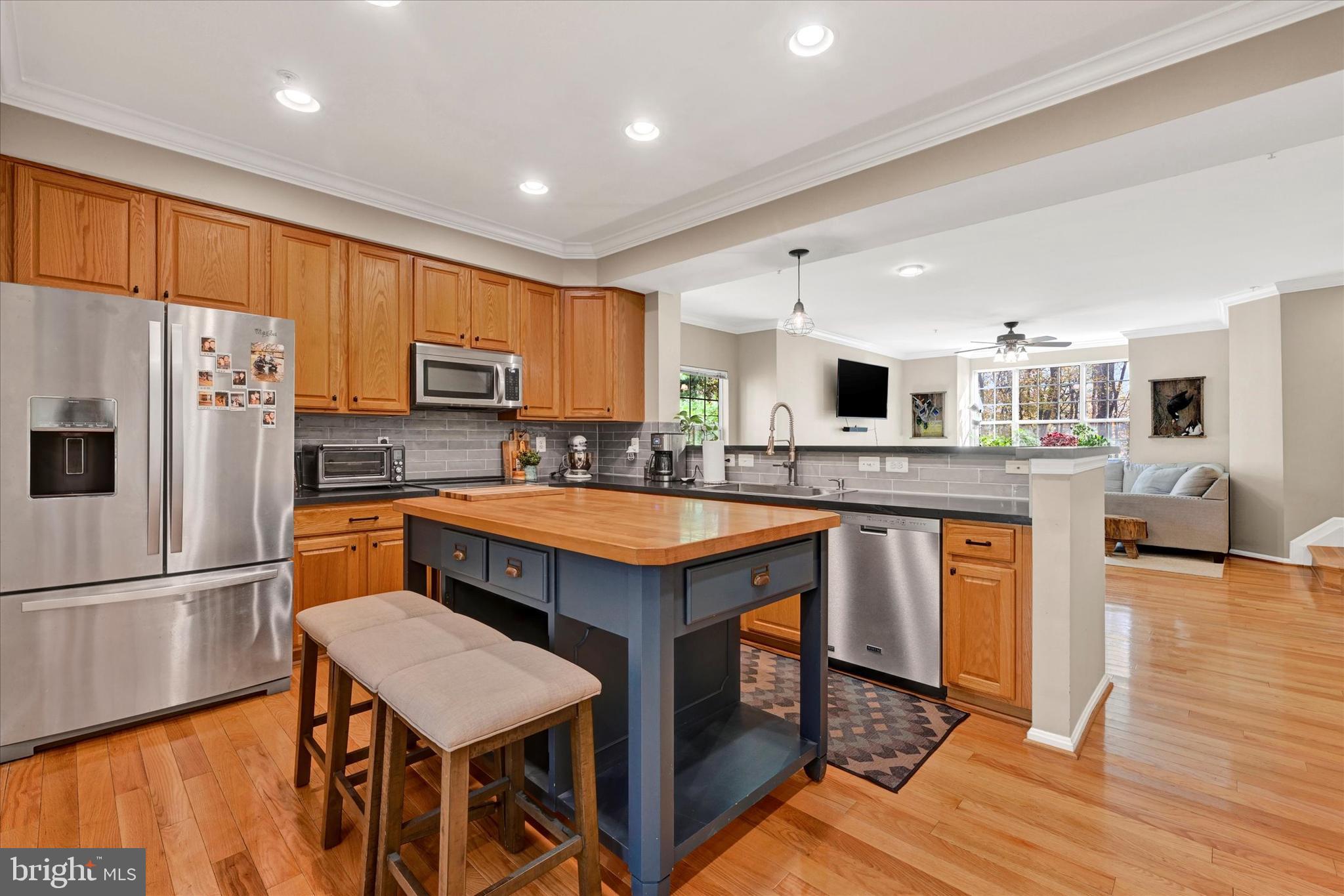 2370 Sandy Walk Way Odenton, MD 21113 - Photo 12 of 33 a kitchen with stainless steel appliances granite countertop a refrigerator a stove top oven a sink dishwasher and white cabinets with wooden floor