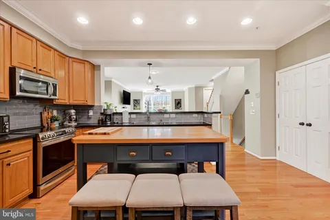 a kitchen with stainless steel appliances granite countertop a stove a sink dishwasher and a refrigerator
