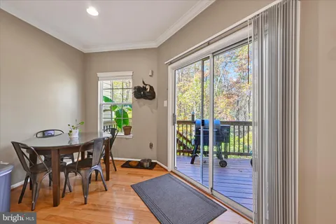 a dining room with furniture wooden floor and a rug
