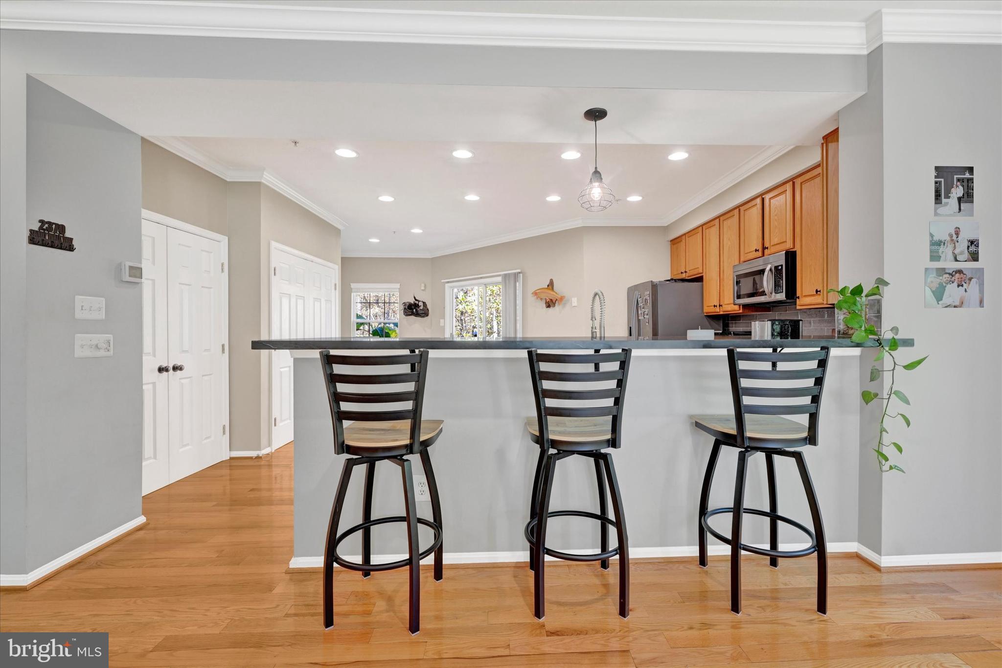 2370 Sandy Walk Way Odenton, MD 21113 - Photo 17 of 33 a view of kitchen with stainless steel appliances kitchen island microwave and wooden floor