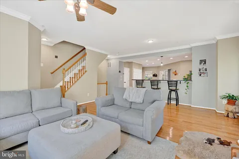 a living room with furniture and a dining table