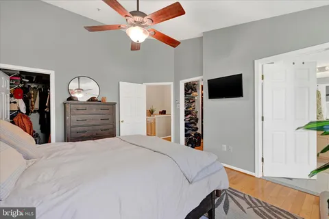 a bedroom with a bed and a flat tv screen on dresser
