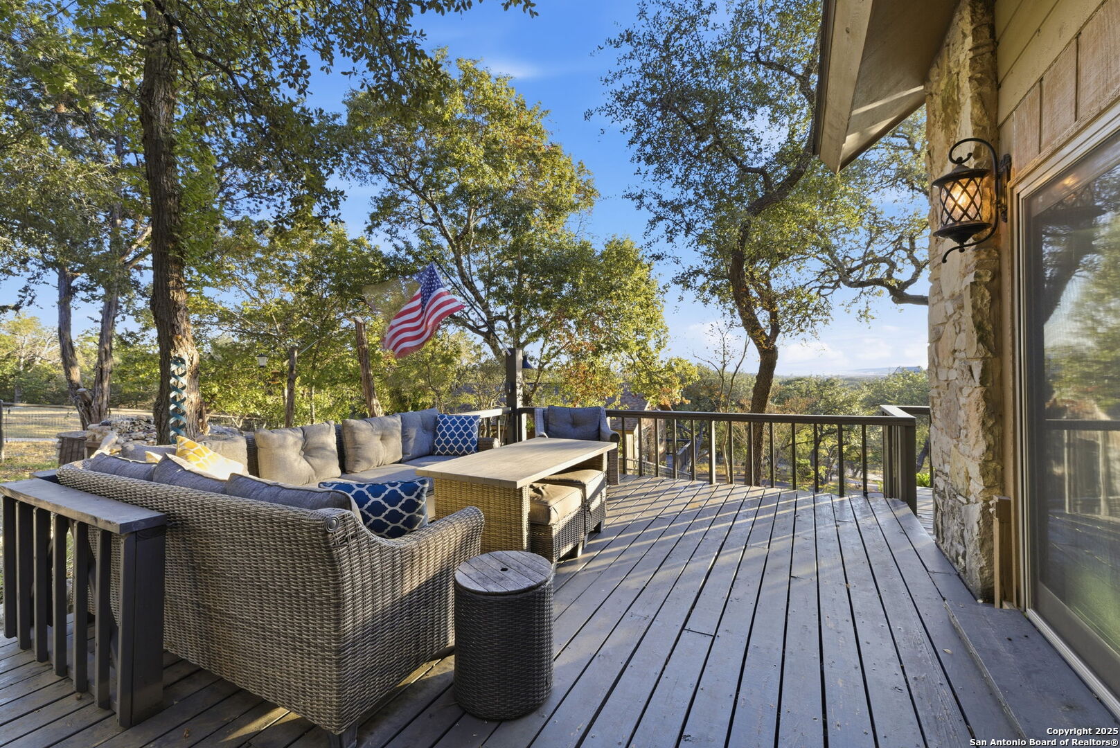 1072 Summit Canyon Lake, TX 78133 - Photo 15 of 50 a view of a roof deck with table and chairs a barbeque with wooden floor and fence