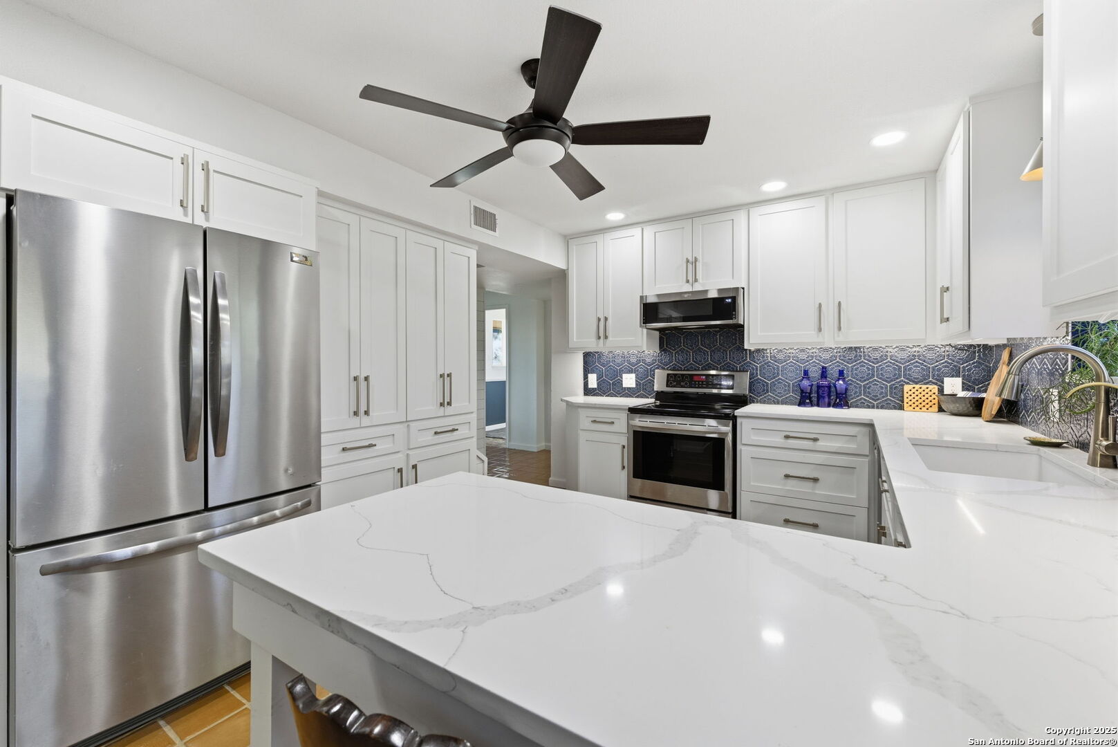 1072 Summit Canyon Lake, TX 78133 - Photo 32 of 50 a kitchen with stainless steel appliances a refrigerator sink and microwave