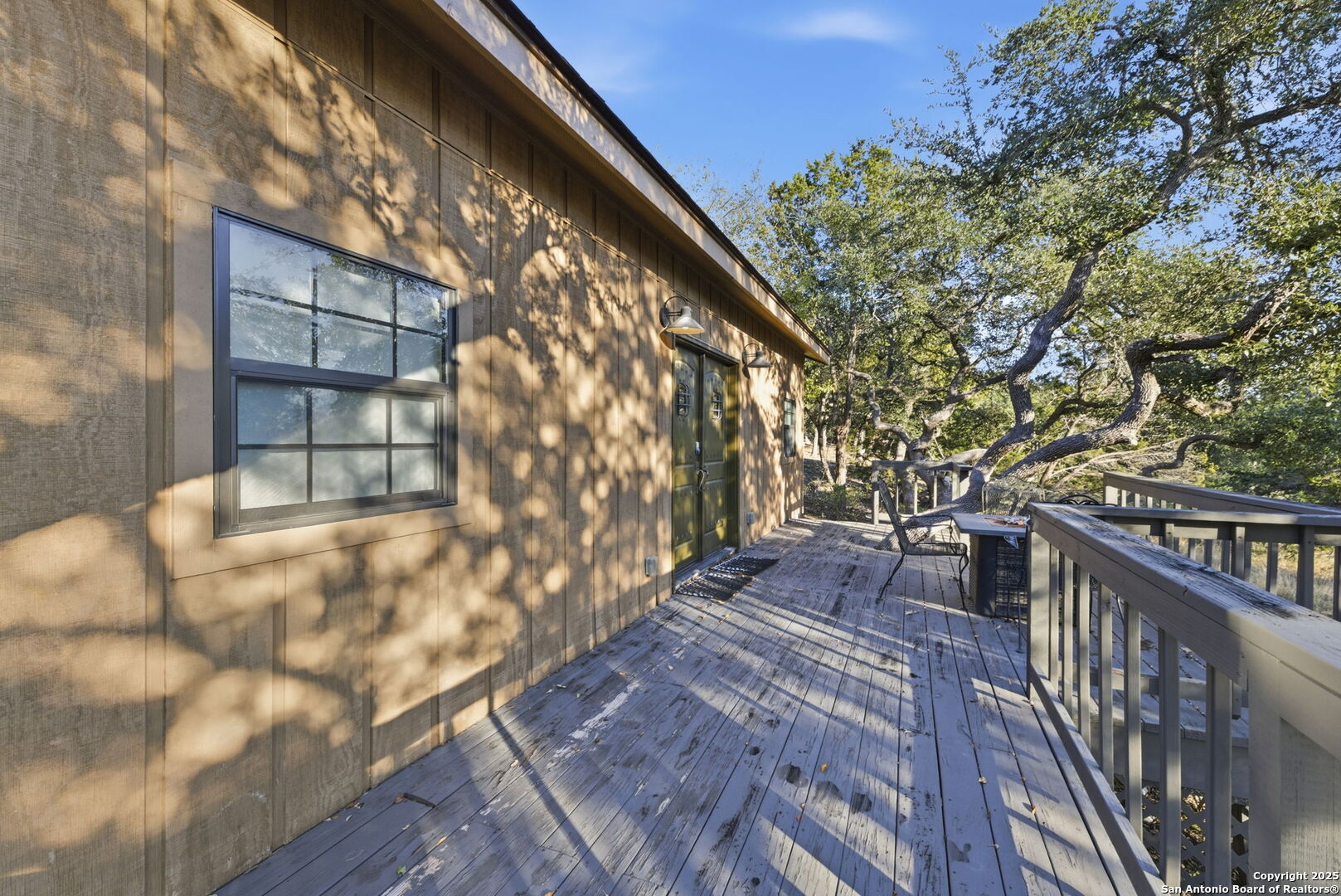 1072 Summit Canyon Lake, TX 78133 - Photo 7 of 50 a balcony with wooden floor and trees