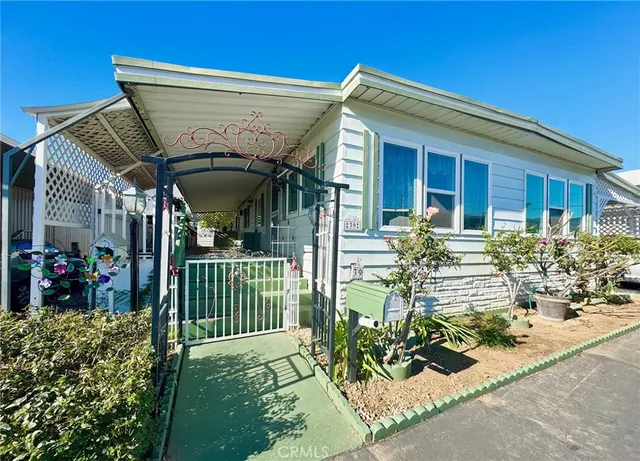 a view of a house with yard and sitting area