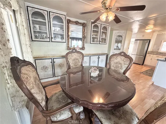 a dining room with furniture and wooden floor
