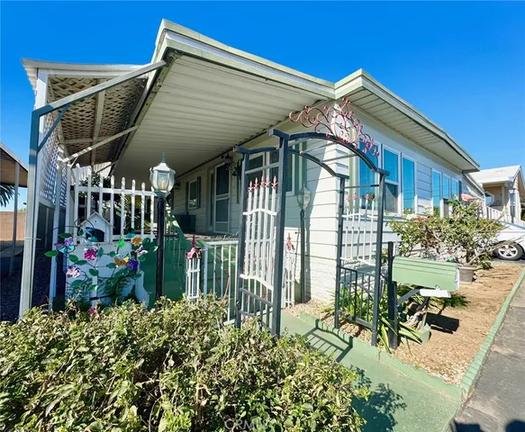 a view of a house with a small yard and plants