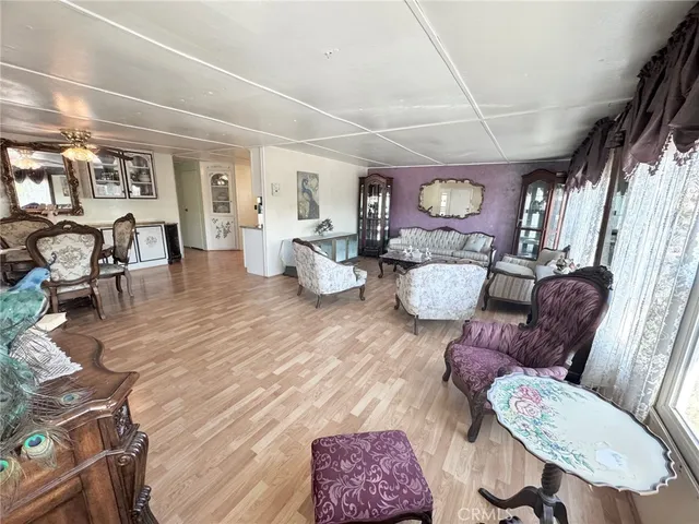 a living room with furniture wooden floor and a fireplace