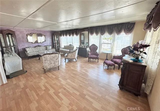 a living room with fireplace furniture and a large window