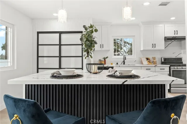 a kitchen with cabinets appliances and a window