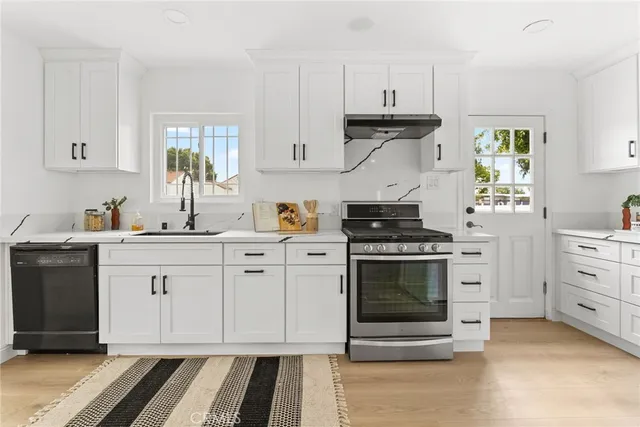 a kitchen with white cabinets sink and white appliances