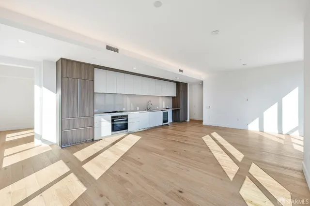 a view of livingroom with kitchen and window