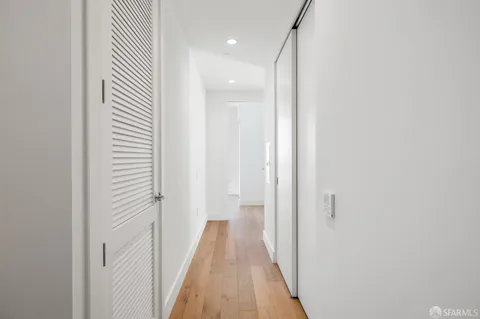 a view of a hallway with wooden floor