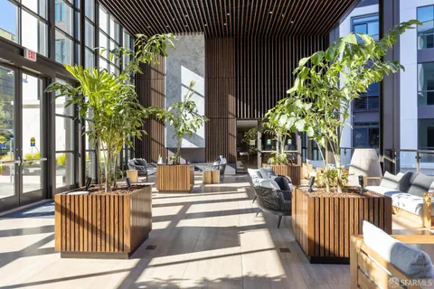 a view of a patio with couches table and chairs and potted plants