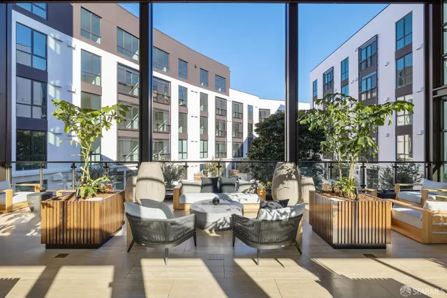a view of a patio with couches and potted plants