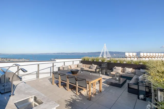 a terrace with outdoor seating and city view