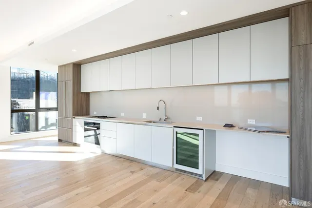 an open kitchen with a sink and cabinets
