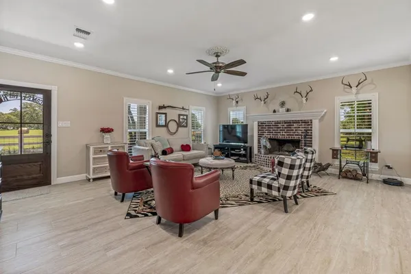 a living room with furniture a fireplace and a window