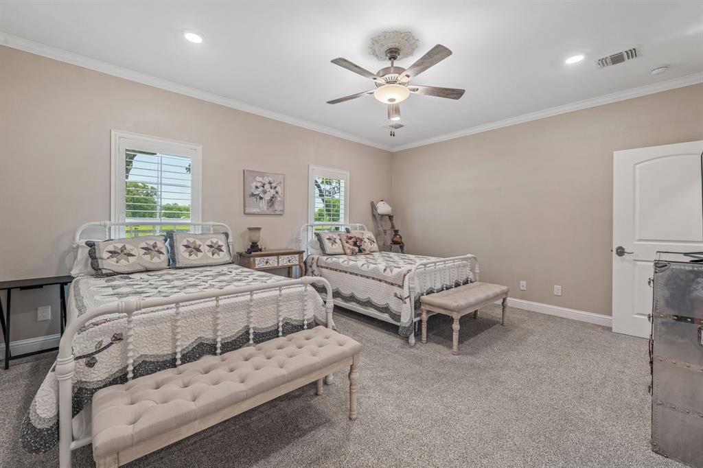 1340 County Road 189 Jonesboro, TX 76538 - Photo 17 of 39 a spacious bedroom with a bed and a chandelier