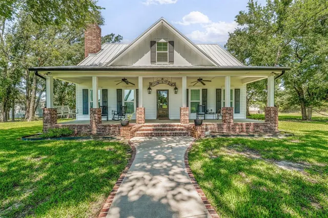 a front view of a house with a yard table and chairs