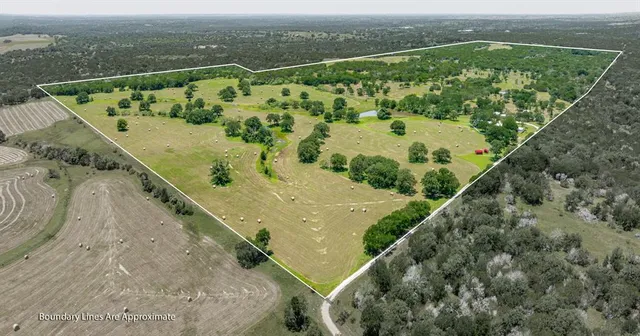 an aerial view of a residential houses with outdoor space