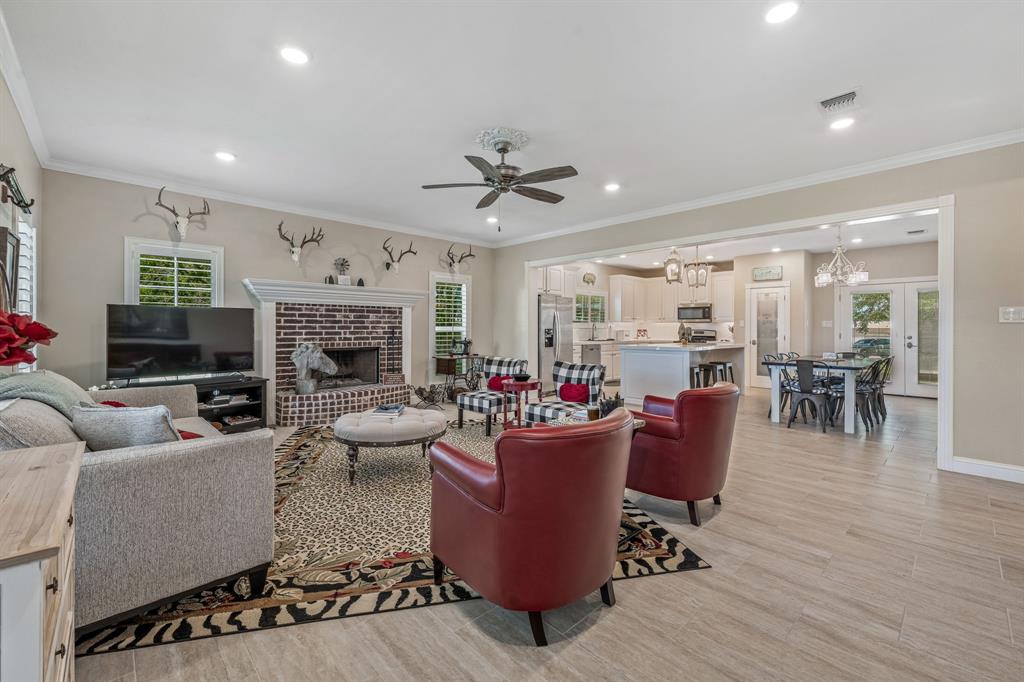 1340 County Road 189 Jonesboro, TX 76538 - Photo 10 of 39 a living room with furniture a fireplace and a chandelier