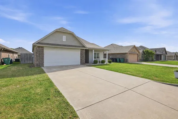 a front view of house with yard and green space